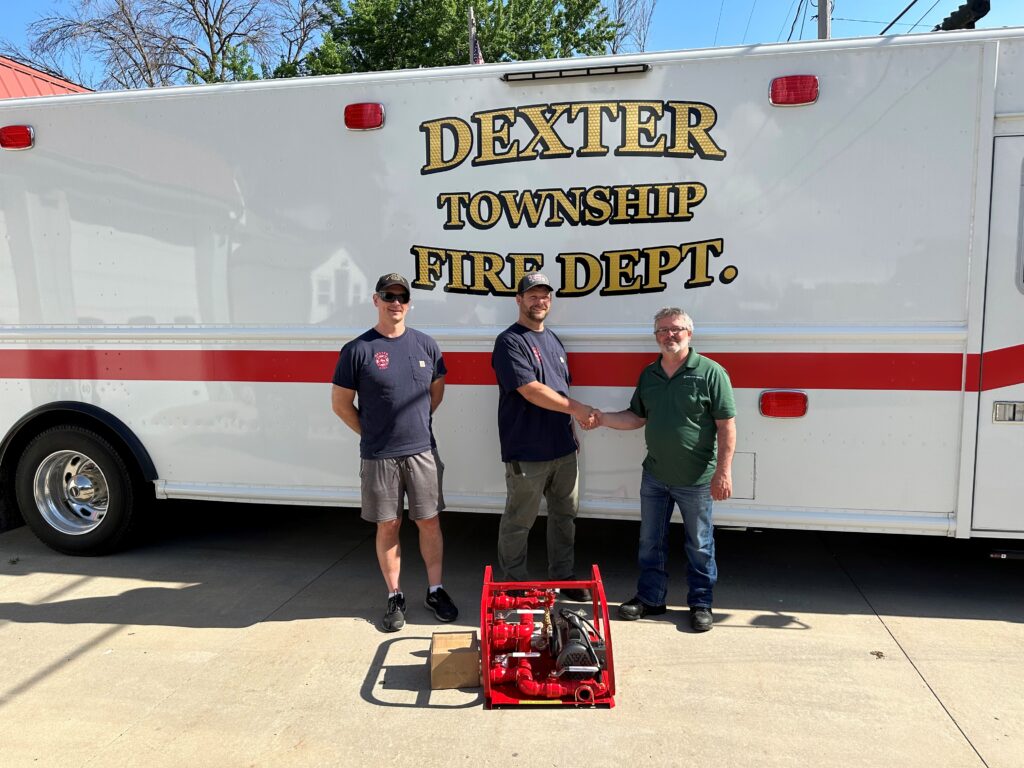Pictured (from left) are: Fire Chief Caleb Howe, Assistant Fire Chief Travis Schneider, and Charles Condon, Great River Energy’s peaking plant operator technician foreperson in front of a Dexter Township Fire Department vehicle.